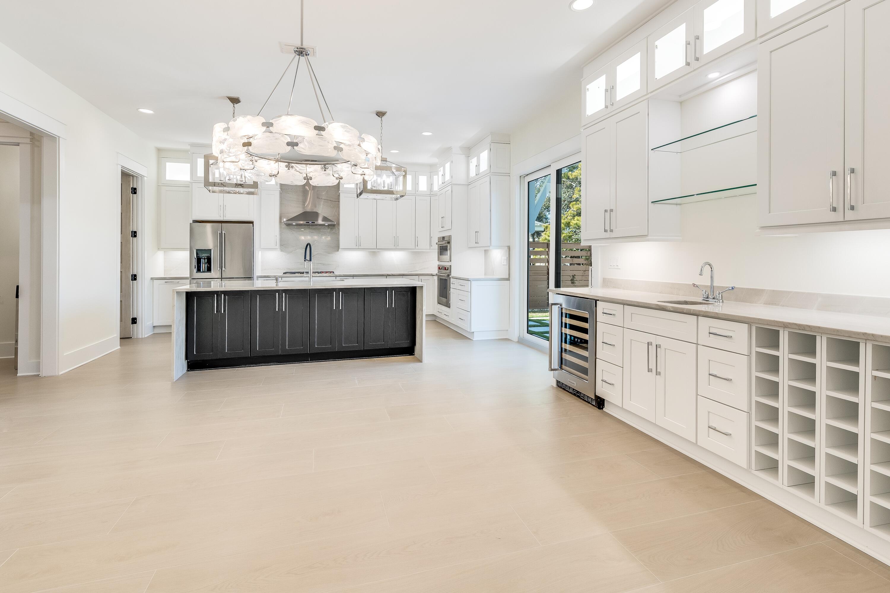63 Maple Street Santa Rosa Beach, FL 32459 - Photo 14 of 88 a large kitchen with kitchen island a sink stainless steel appliances and cabinets
