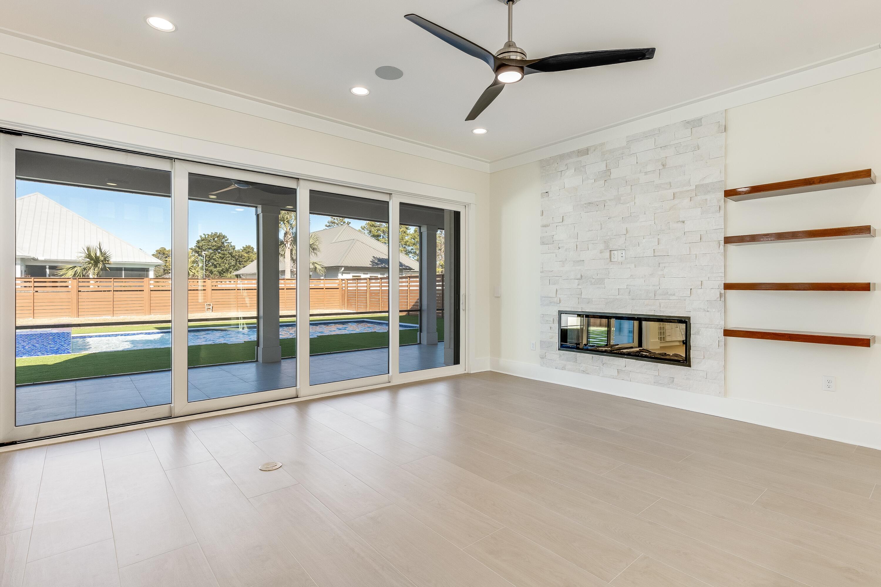 63 Maple Street Santa Rosa Beach, FL 32459 - Photo 16 of 88 an empty room with wooden floor and windows