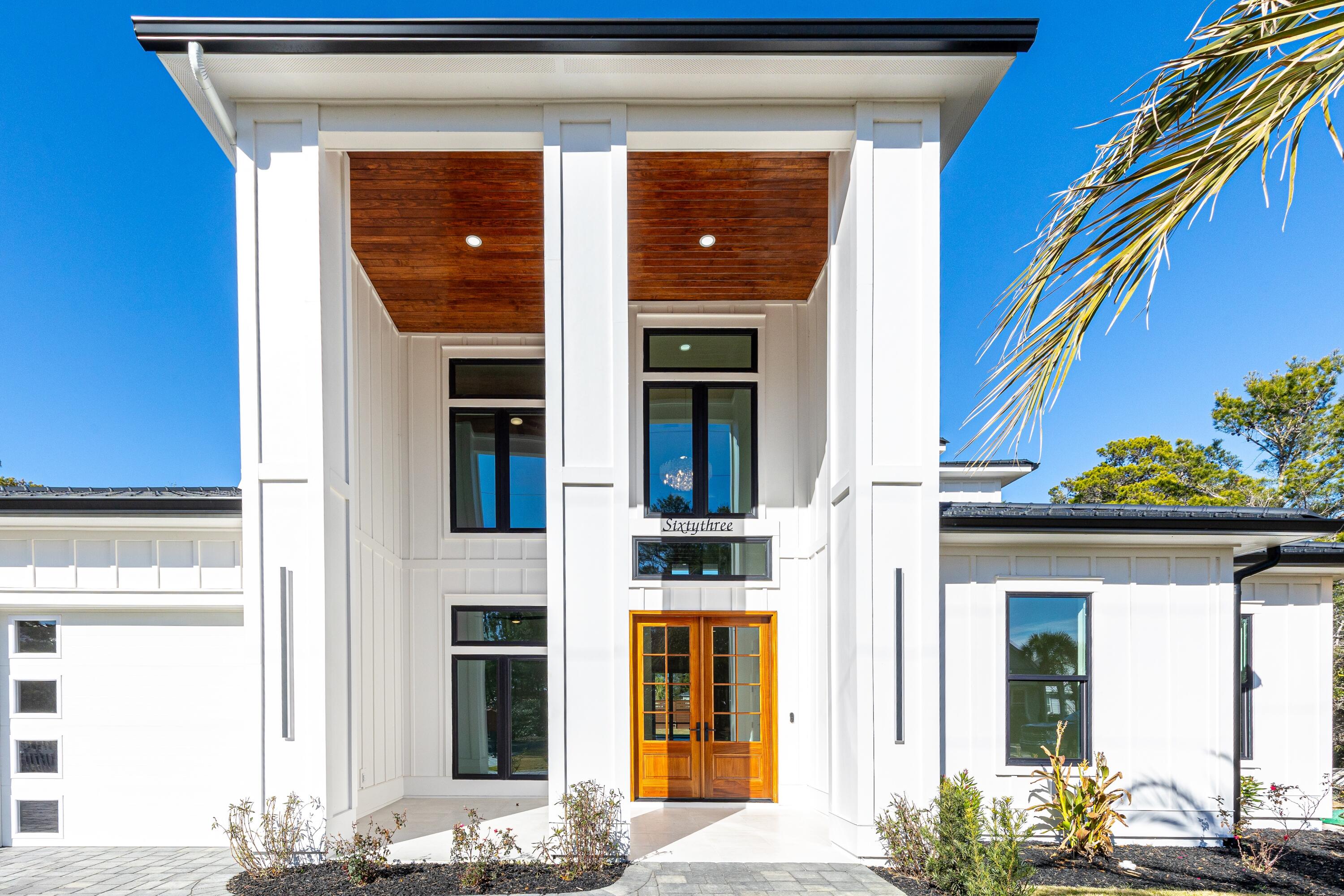 63 Maple Street Santa Rosa Beach, FL 32459 - Photo 2 of 88 a front view of a house with a blue lights