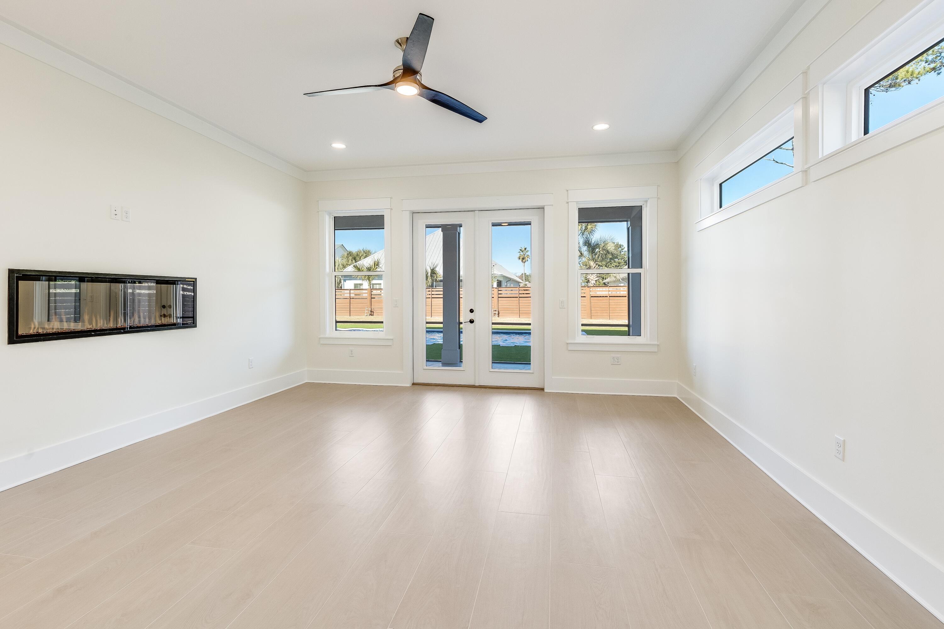 63 Maple Street Santa Rosa Beach, FL 32459 - Photo 30 of 88 a view of an empty room with a window and wooden floor