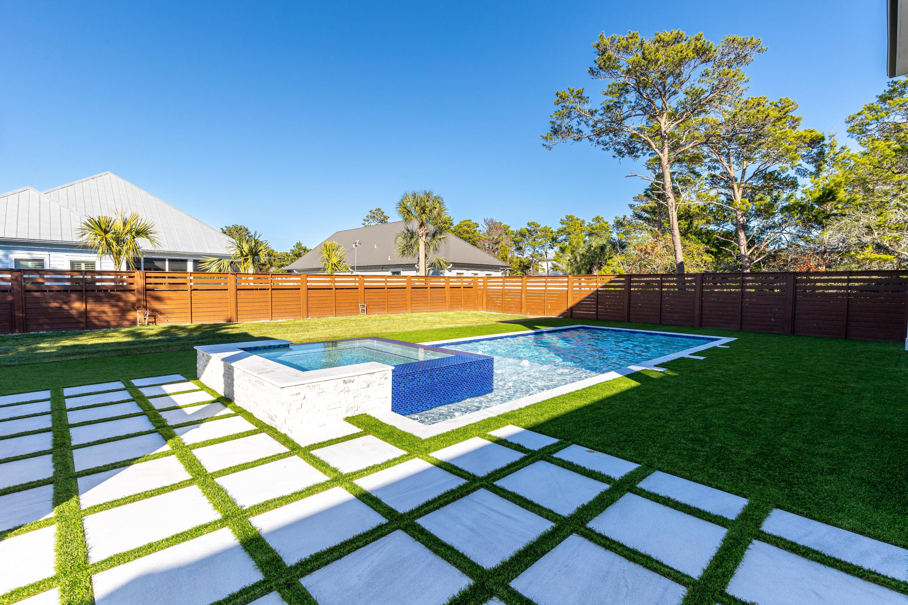 63 Maple Street Santa Rosa Beach, FL 32459 - Photo 56 of 88 a view of swimming pool with seating area and trees in the background