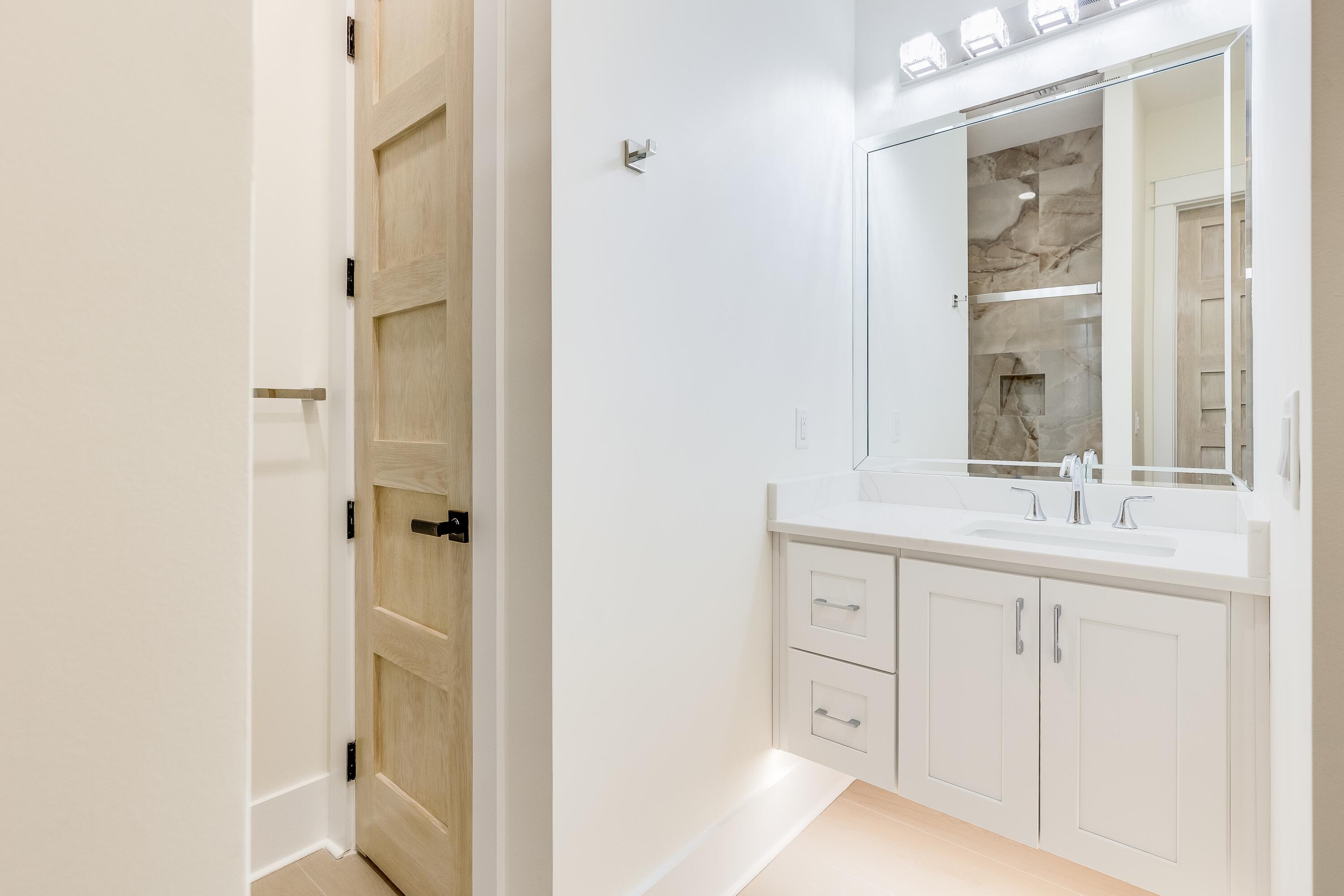 63 Maple Street Santa Rosa Beach, FL 32459 - Photo 10 of 88 a bathroom with a double vanity sink and a mirror