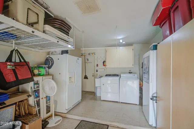 a kitchen with refrigerator and cabinets