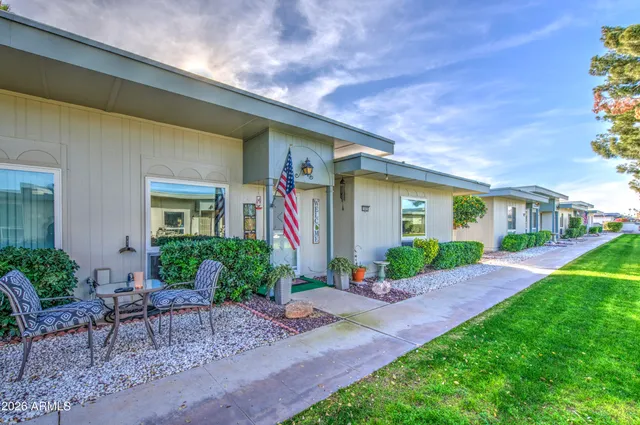 a front view of a house with garden and porch