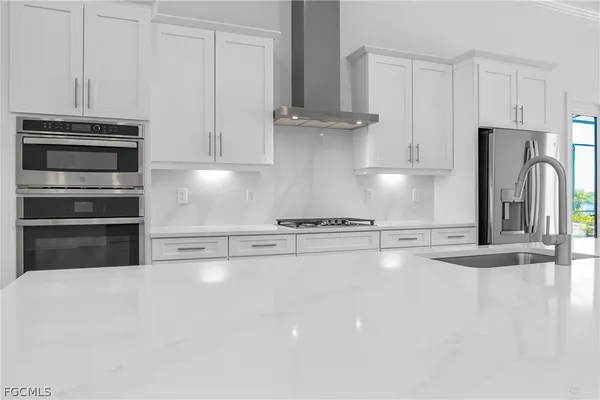a kitchen with stainless steel appliances a refrigerator and a stove