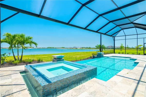 a view of a swimming pool with a lawn chairs under an umbrella