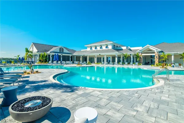 a view of a house with swimming pool and a yard