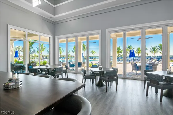 a view of a dining room with furniture and floor to ceiling windows