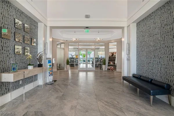 a lobby with furniture and a rug