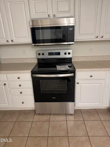 a stove top oven sitting inside of a kitchen