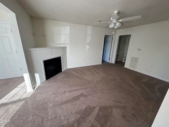 a view of empty room with fireplace