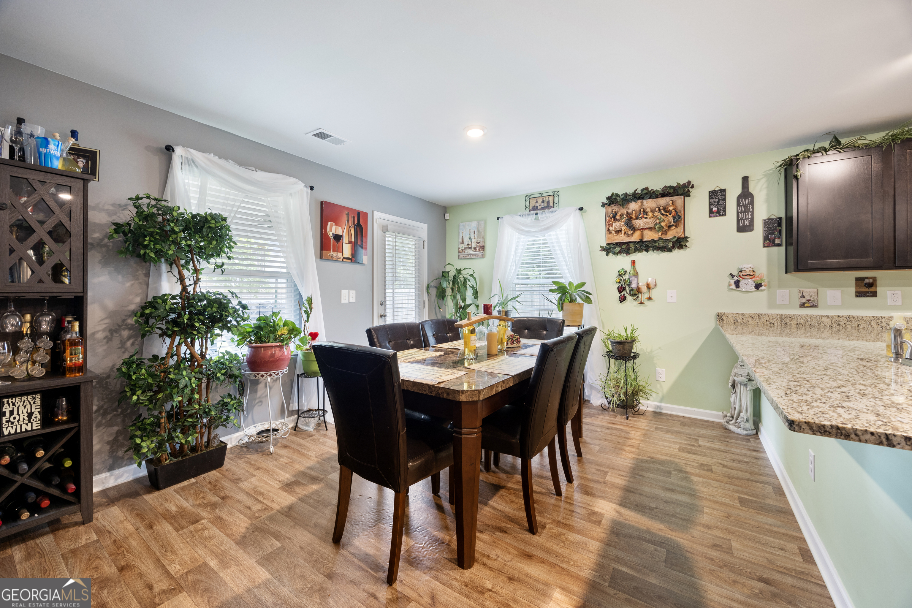 94 Galway Lane Hampton, GA 30228 - Photo 11 of 25 a view of a dining room with furniture and wooden floor