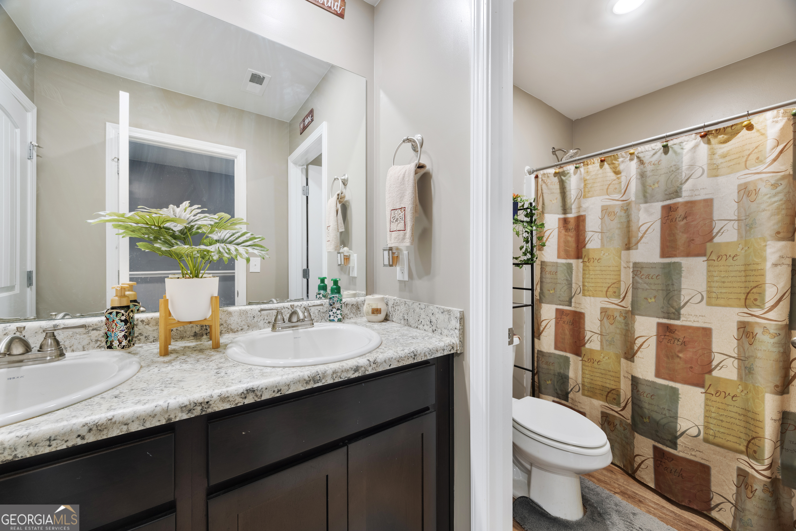 94 Galway Lane Hampton, GA 30228 - Photo 17 of 25 a bathroom with a granite countertop sink toilet and shower