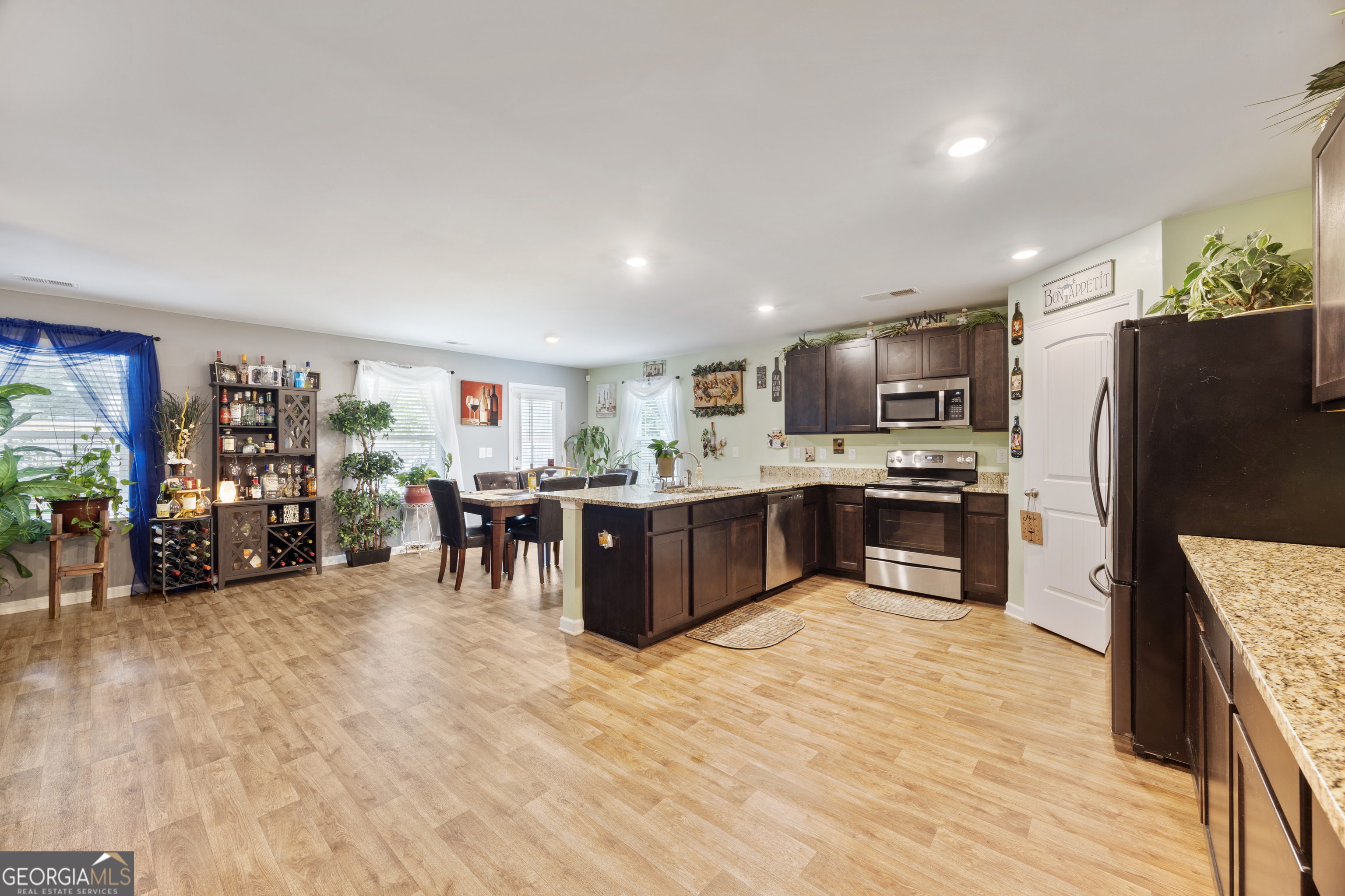 94 Galway Lane Hampton, GA 30228 - Photo 22 of 25 a kitchen with stainless steel appliances a refrigerator and a wooden floor