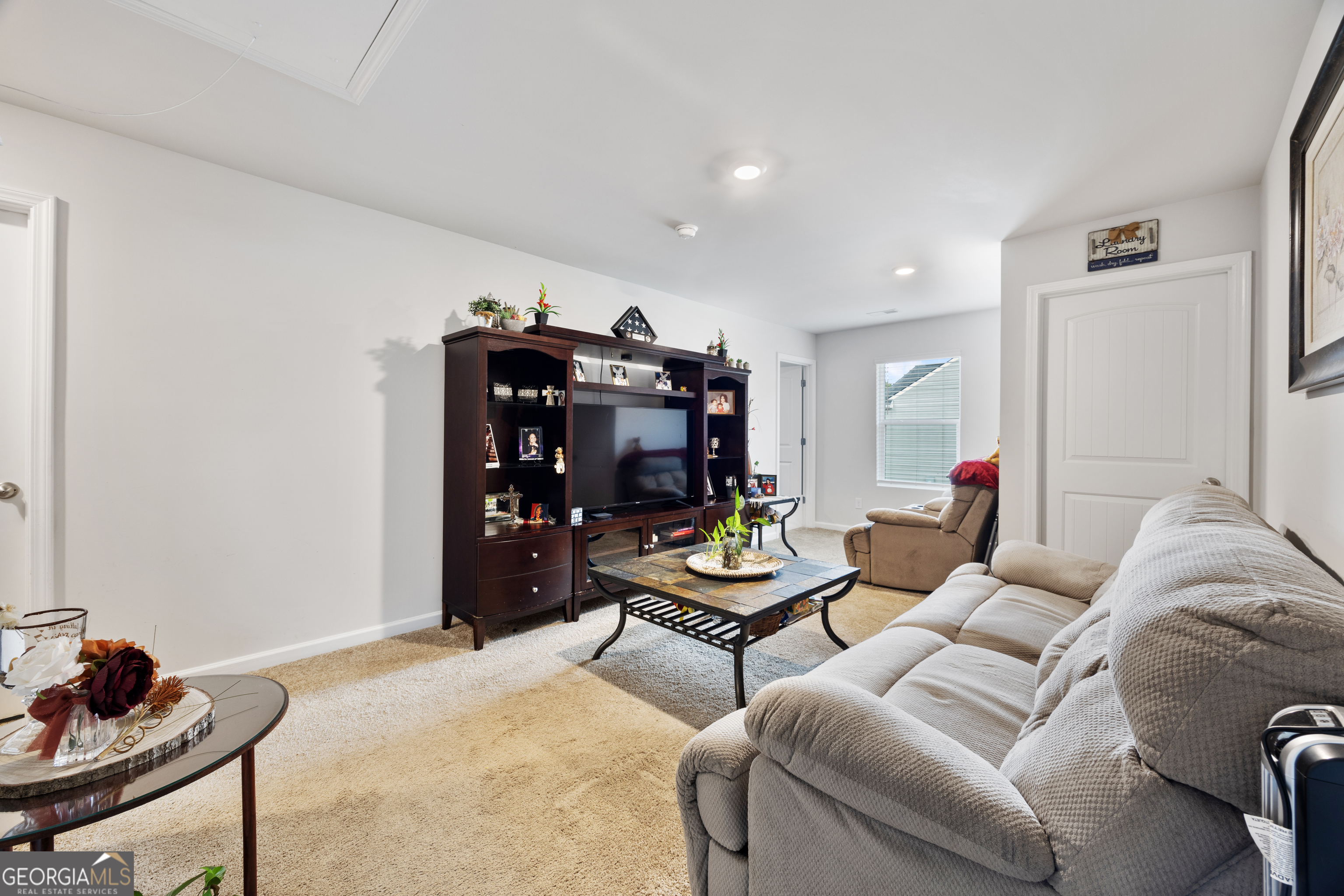 94 Galway Lane Hampton, GA 30228 - Photo 7 of 25 a living room with furniture and a wooden floor