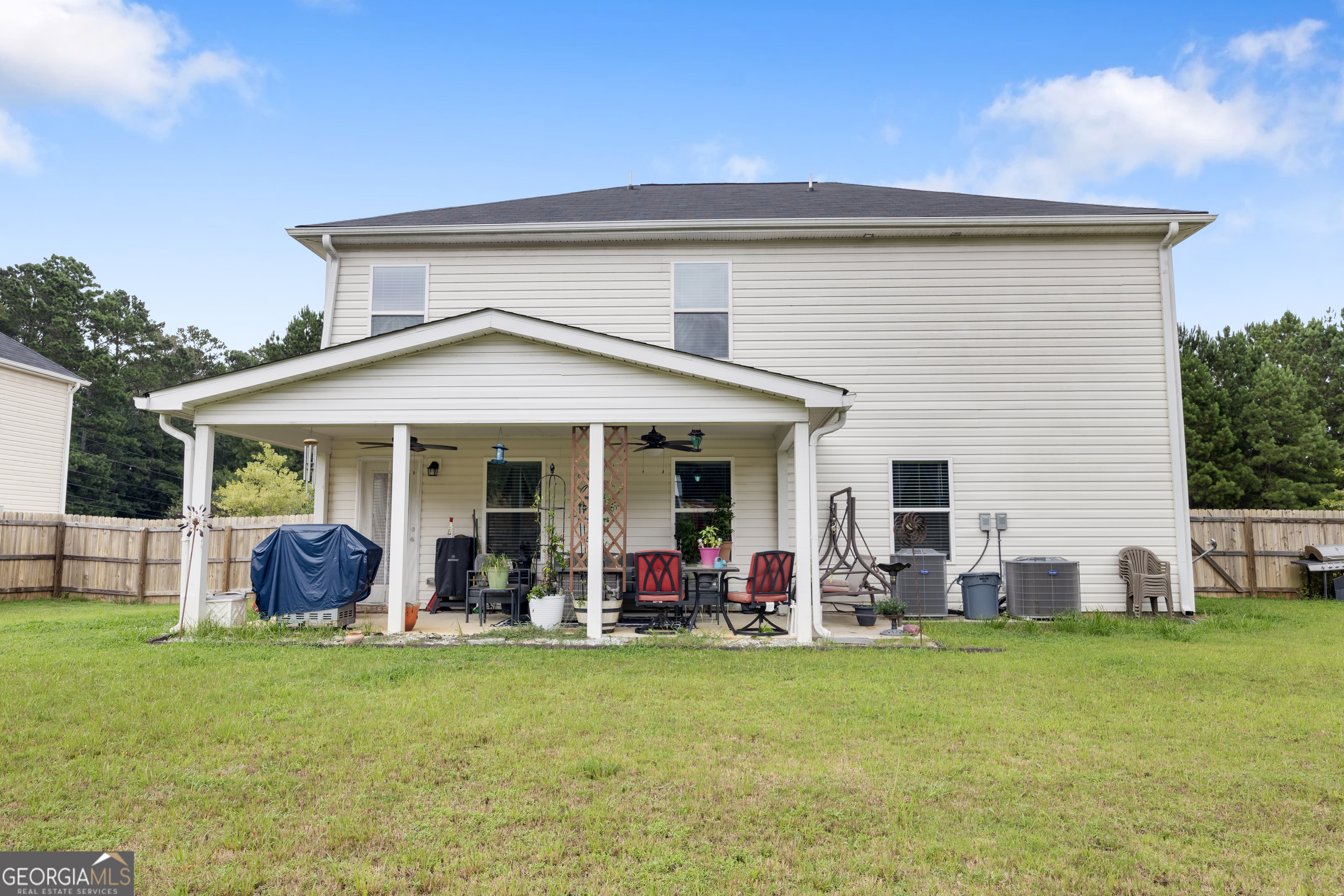 94 Galway Lane Hampton, GA 30228 - Photo 9 of 25 a view of a house with a backyard and a patio