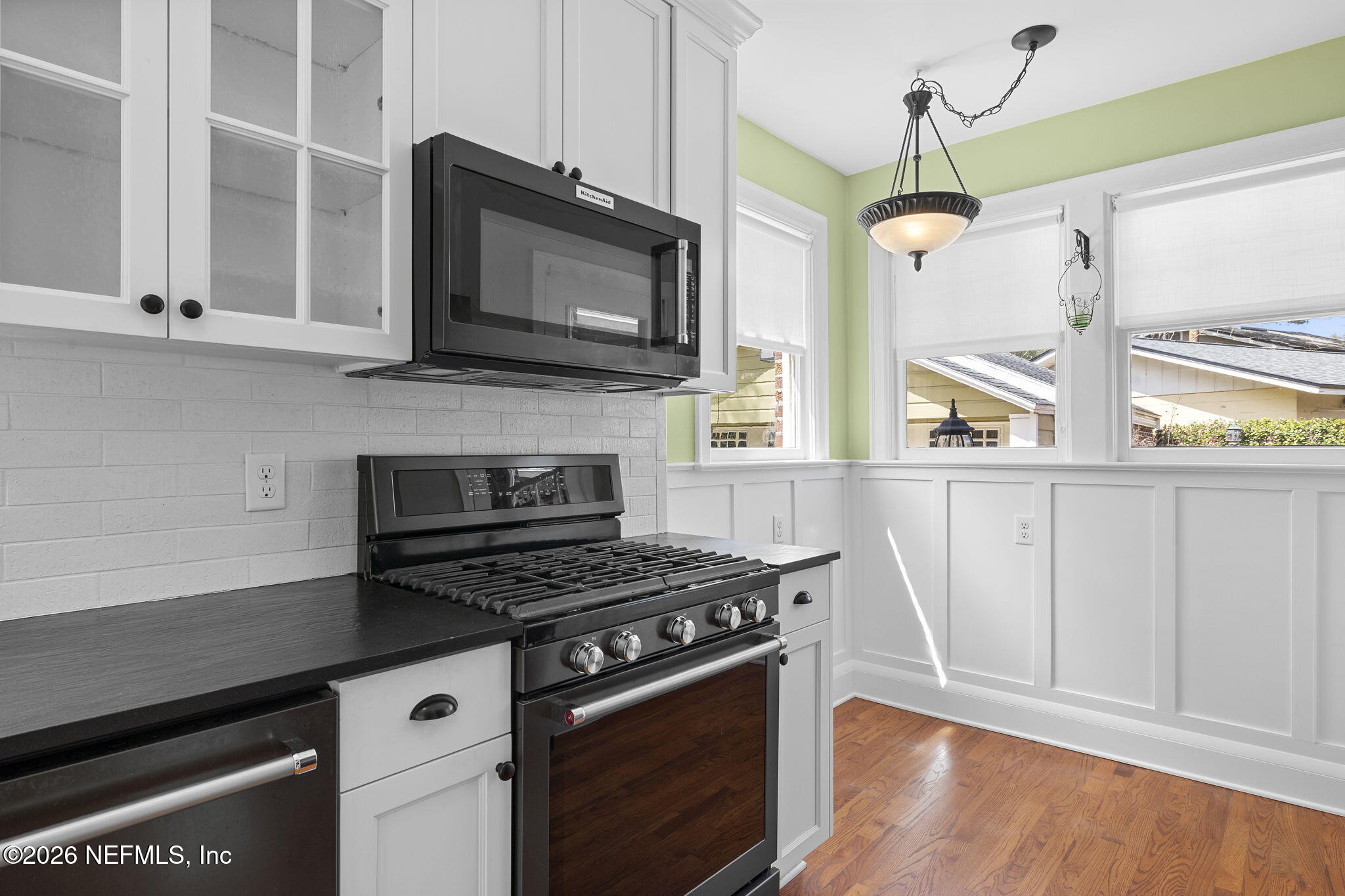 1127 Riviera Street Jacksonville, FL 32207 - Photo 14 of 40 a kitchen with stainless steel appliances a stove a microwave and cabinets