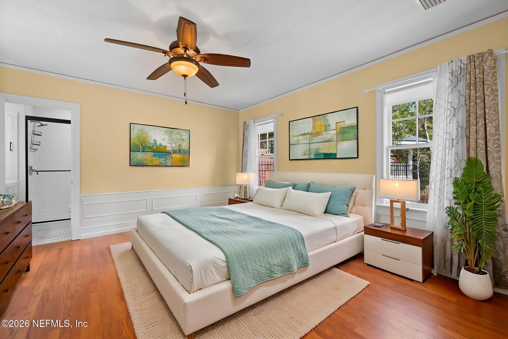 1127 Riviera Street Jacksonville, FL 32207 - Photo 19 of 40 a bedroom with a large bed a chandelier and potted plant