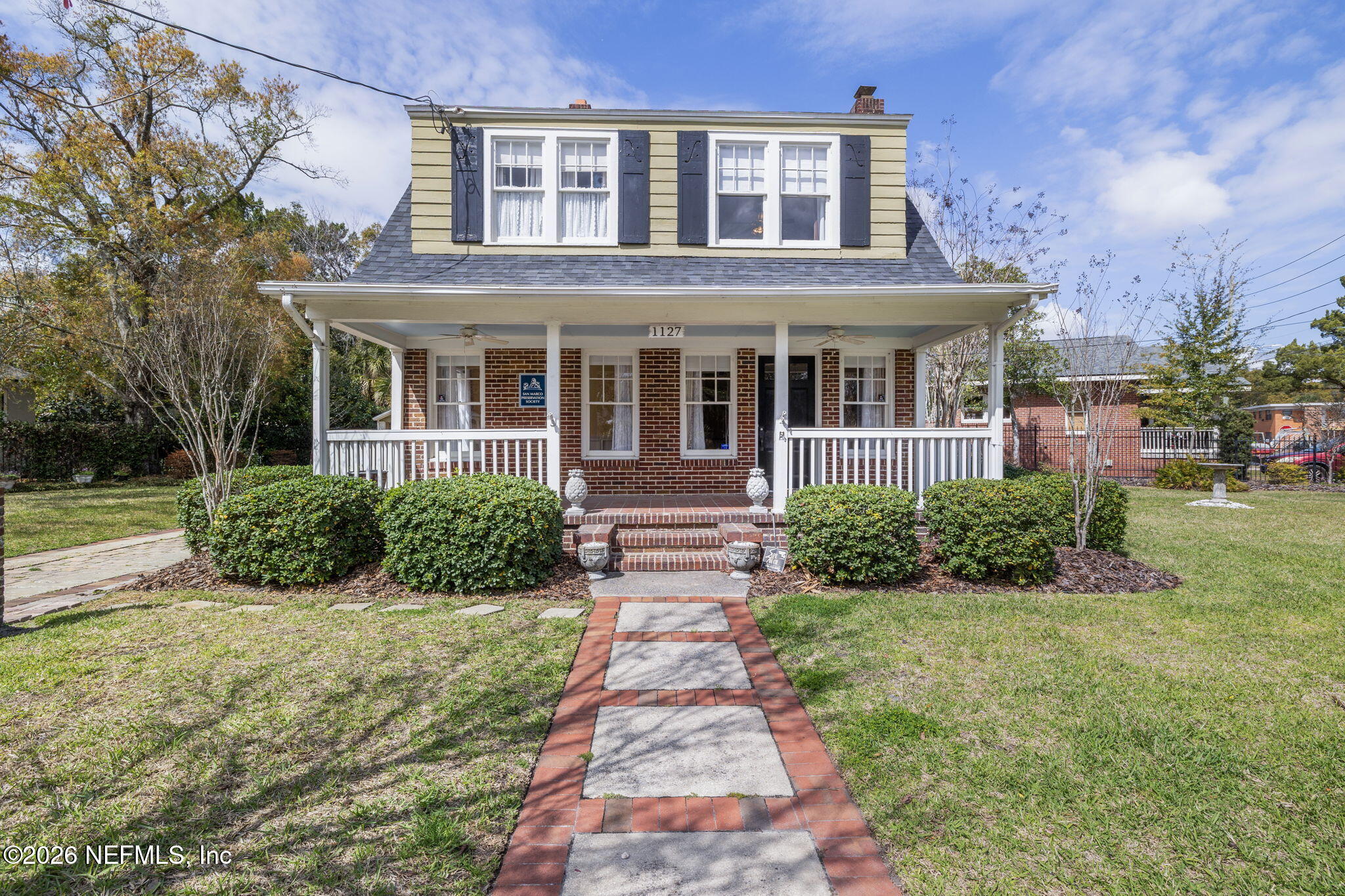 1127 Riviera Street Jacksonville, FL 32207 - Photo 2 of 40 front view of a brick house with a yard
