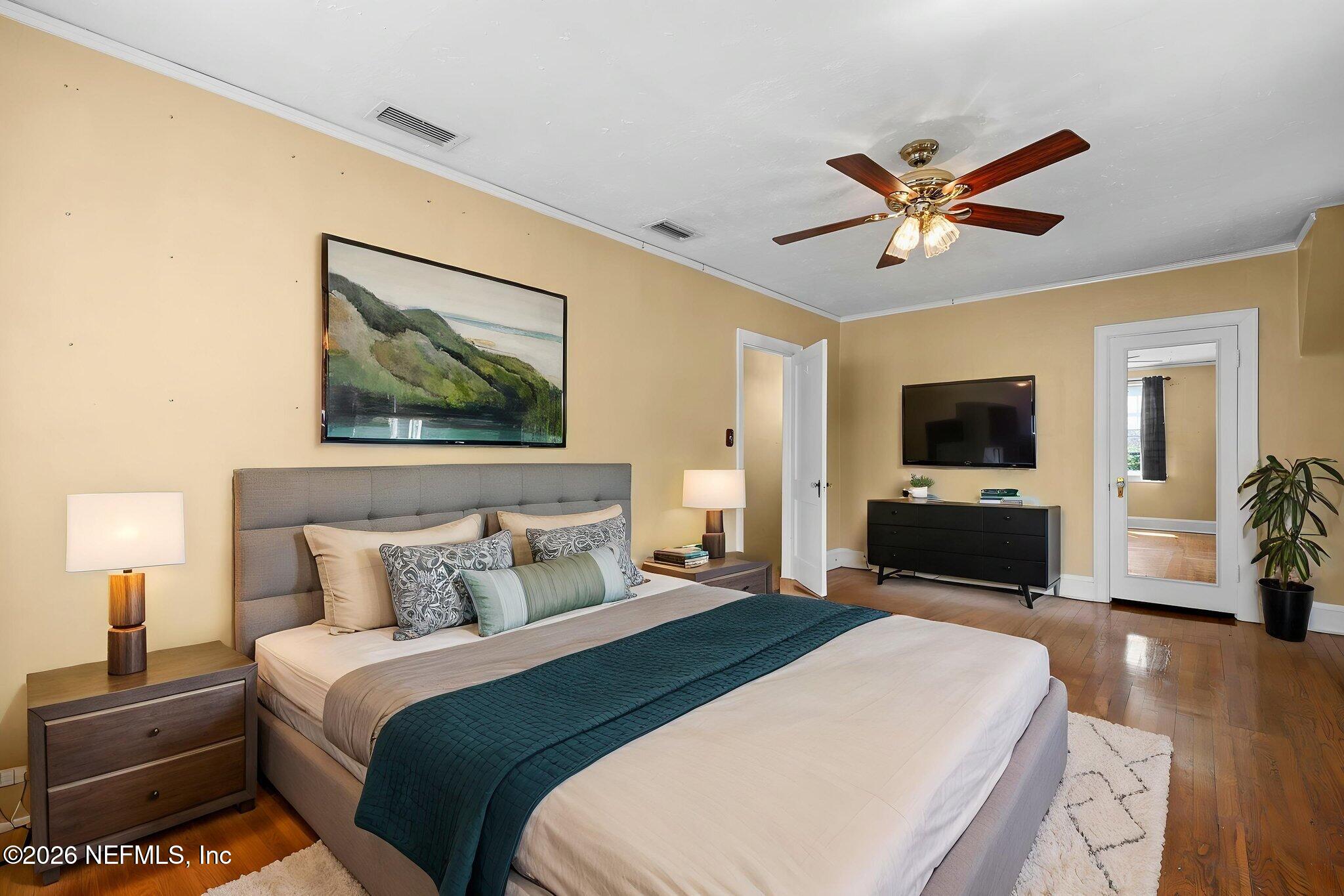 1127 Riviera Street Jacksonville, FL 32207 - Photo 25 of 40 a bedroom with a large bed and a tv