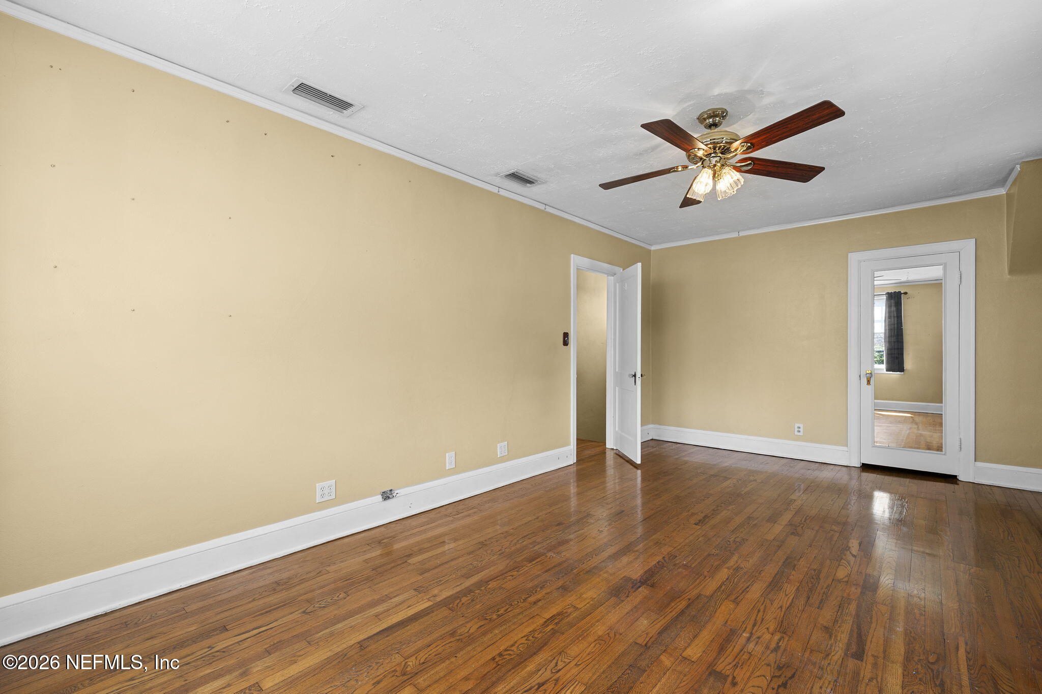 1127 Riviera Street Jacksonville, FL 32207 - Photo 26 of 40 a view of an empty room with wooden floor and a window