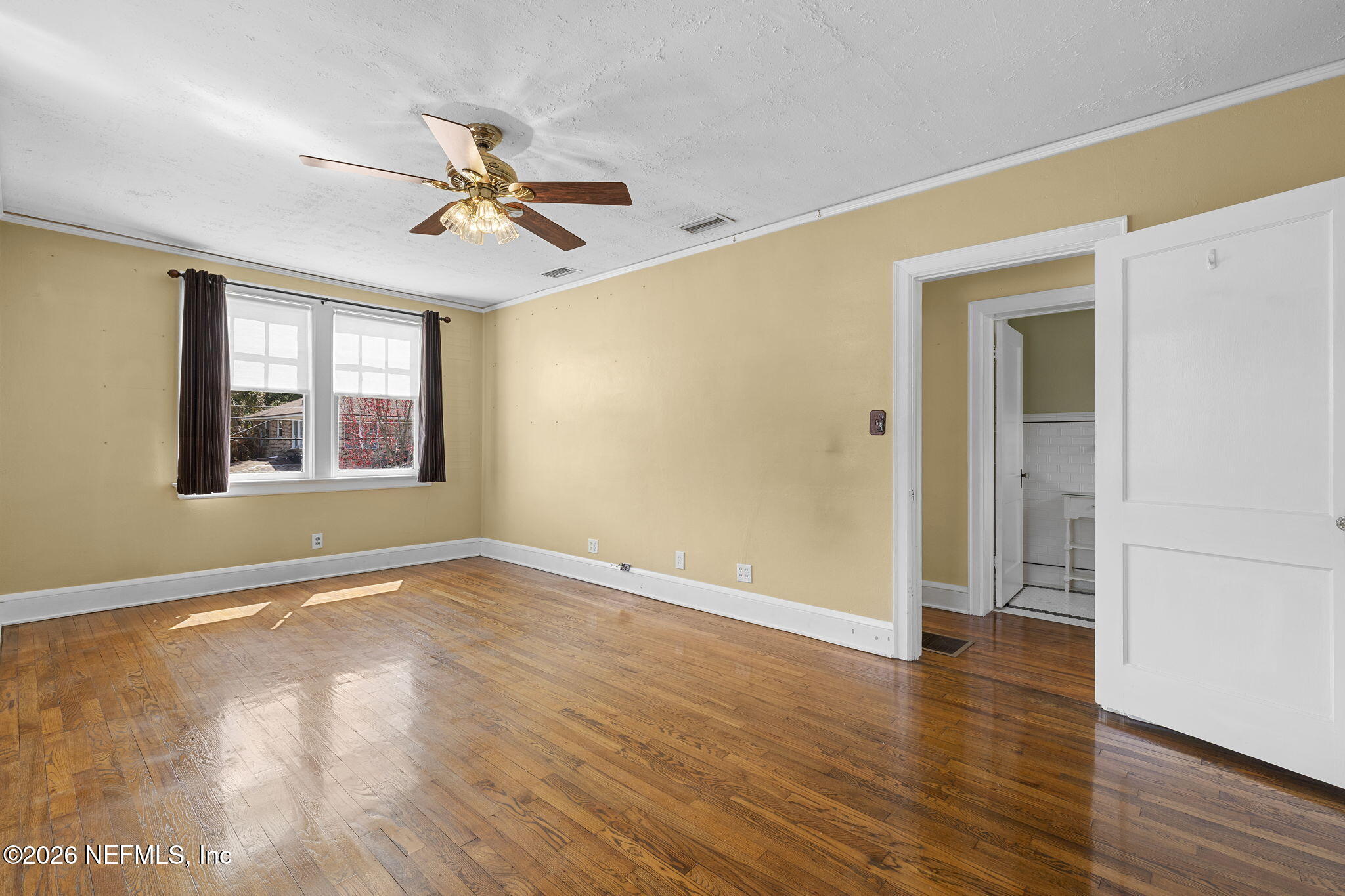 1127 Riviera Street Jacksonville, FL 32207 - Photo 27 of 40 a view of an empty room with window and wooden floor