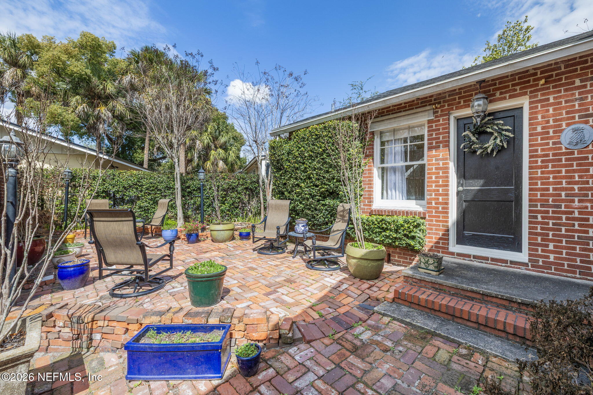 1127 Riviera Street Jacksonville, FL 32207 - Photo 35 of 40 a view of a patio with couches table and chairs and potted plants