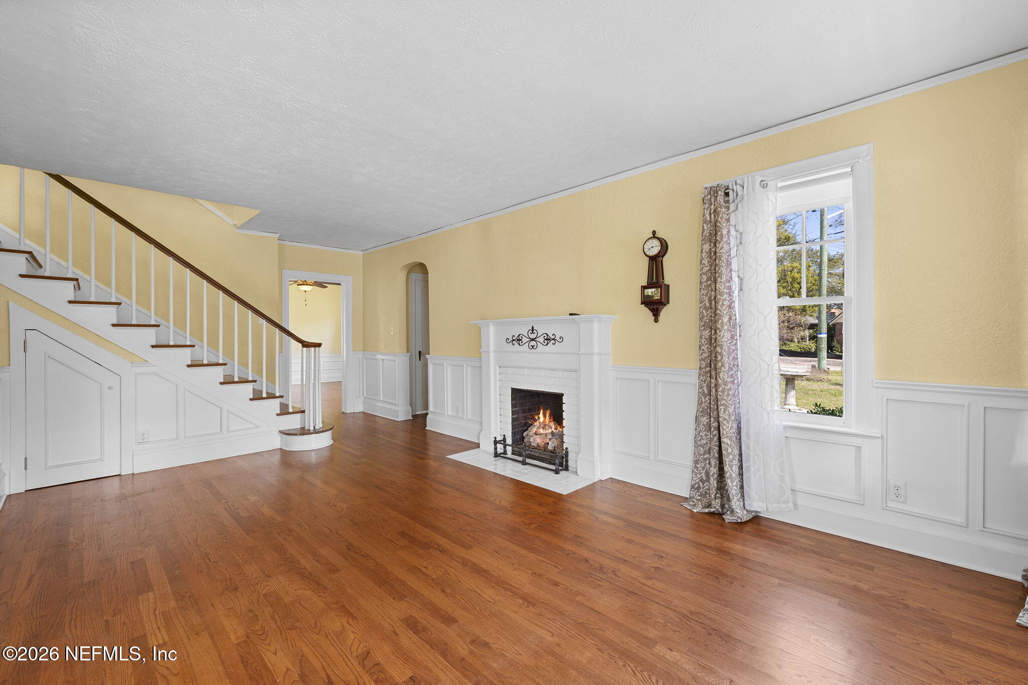 1127 Riviera Street Jacksonville, FL 32207 - Photo 6 of 40 a view of a livingroom with wooden floor fireplace and staircase