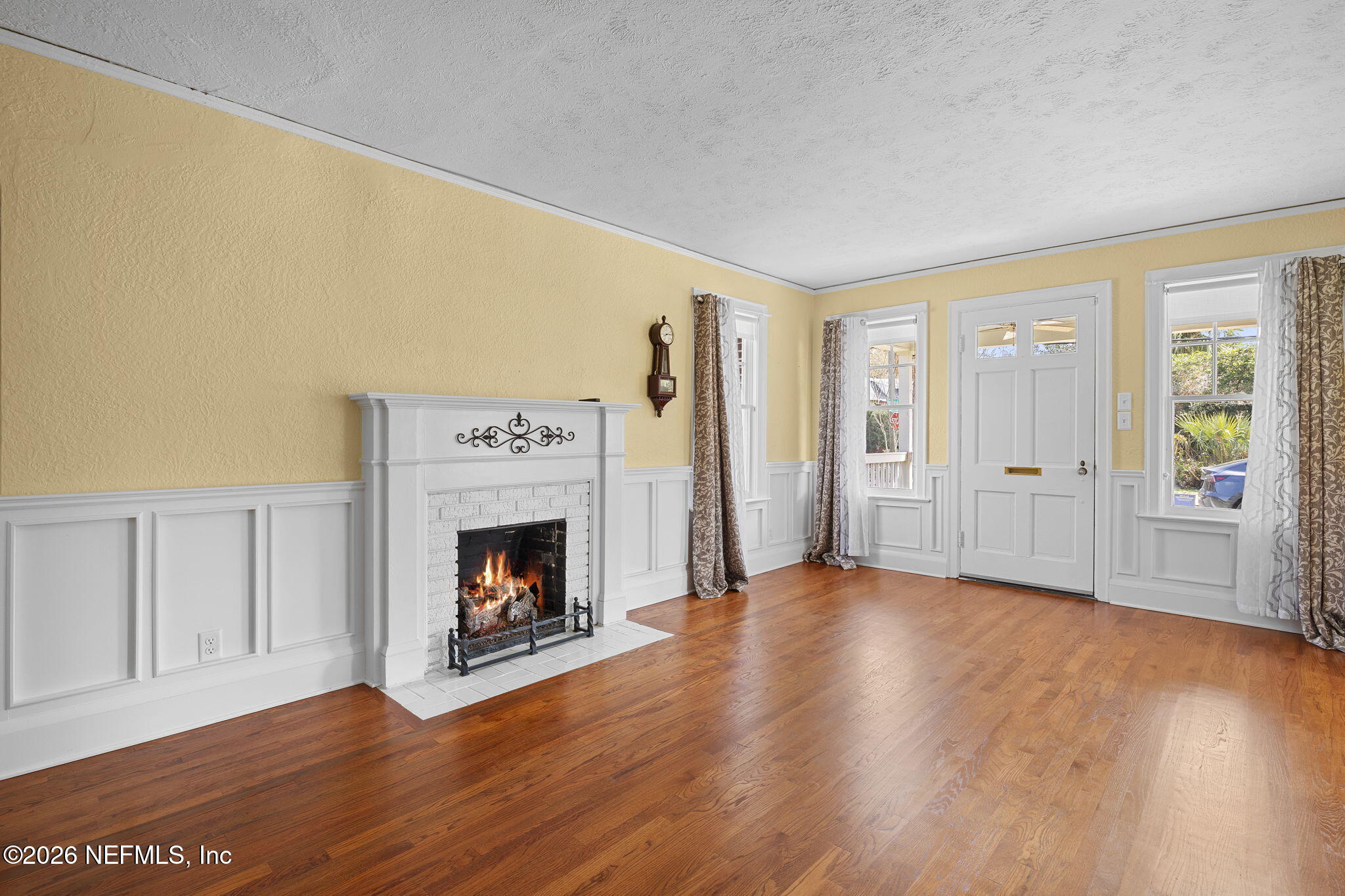 1127 Riviera Street Jacksonville, FL 32207 - Photo 7 of 40 a view of an empty room with wooden floor fireplace and a window
