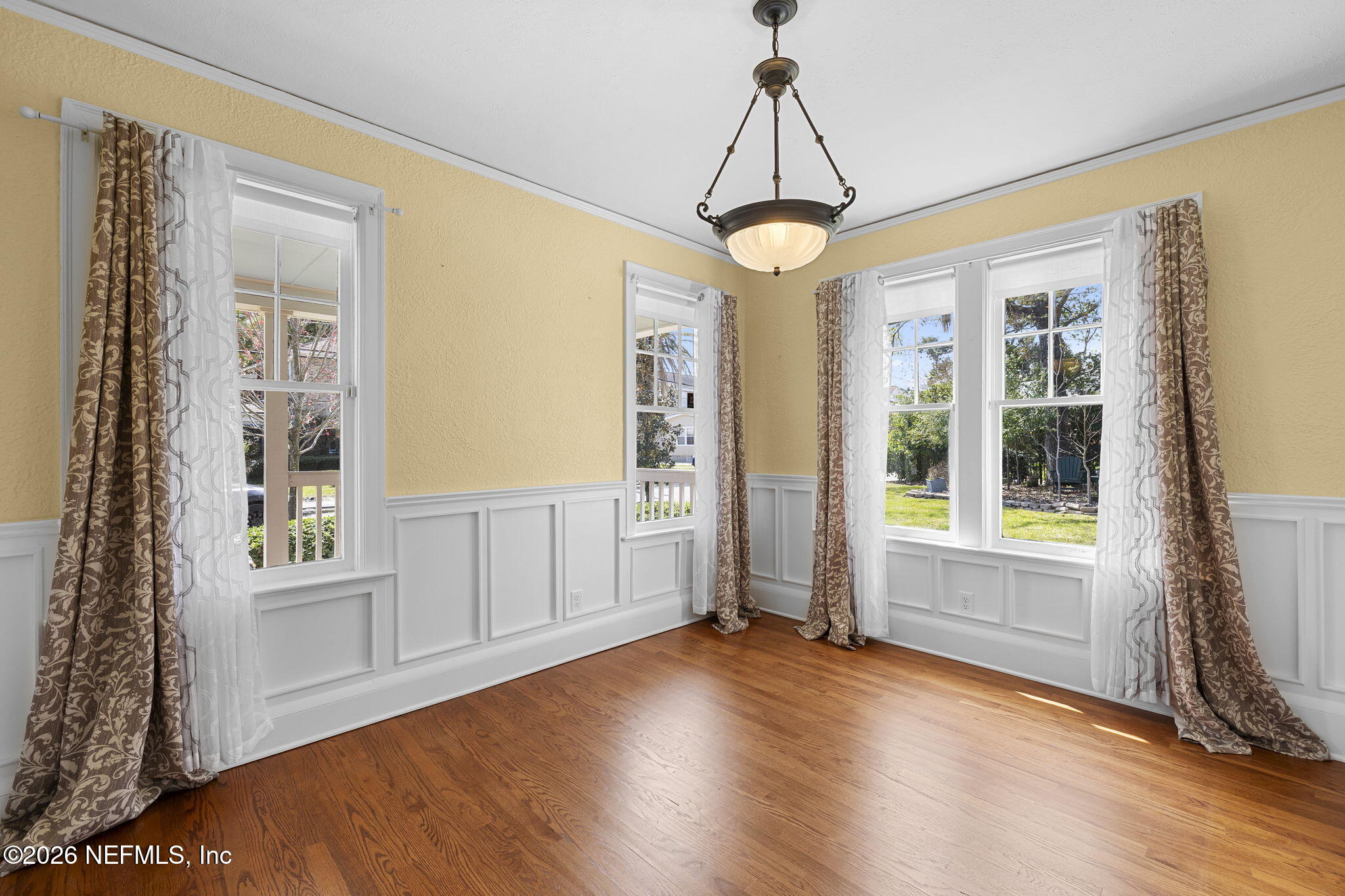 1127 Riviera Street Jacksonville, FL 32207 - Photo 10 of 40 a view of a livingroom with wooden floor a ceiling fan and windows