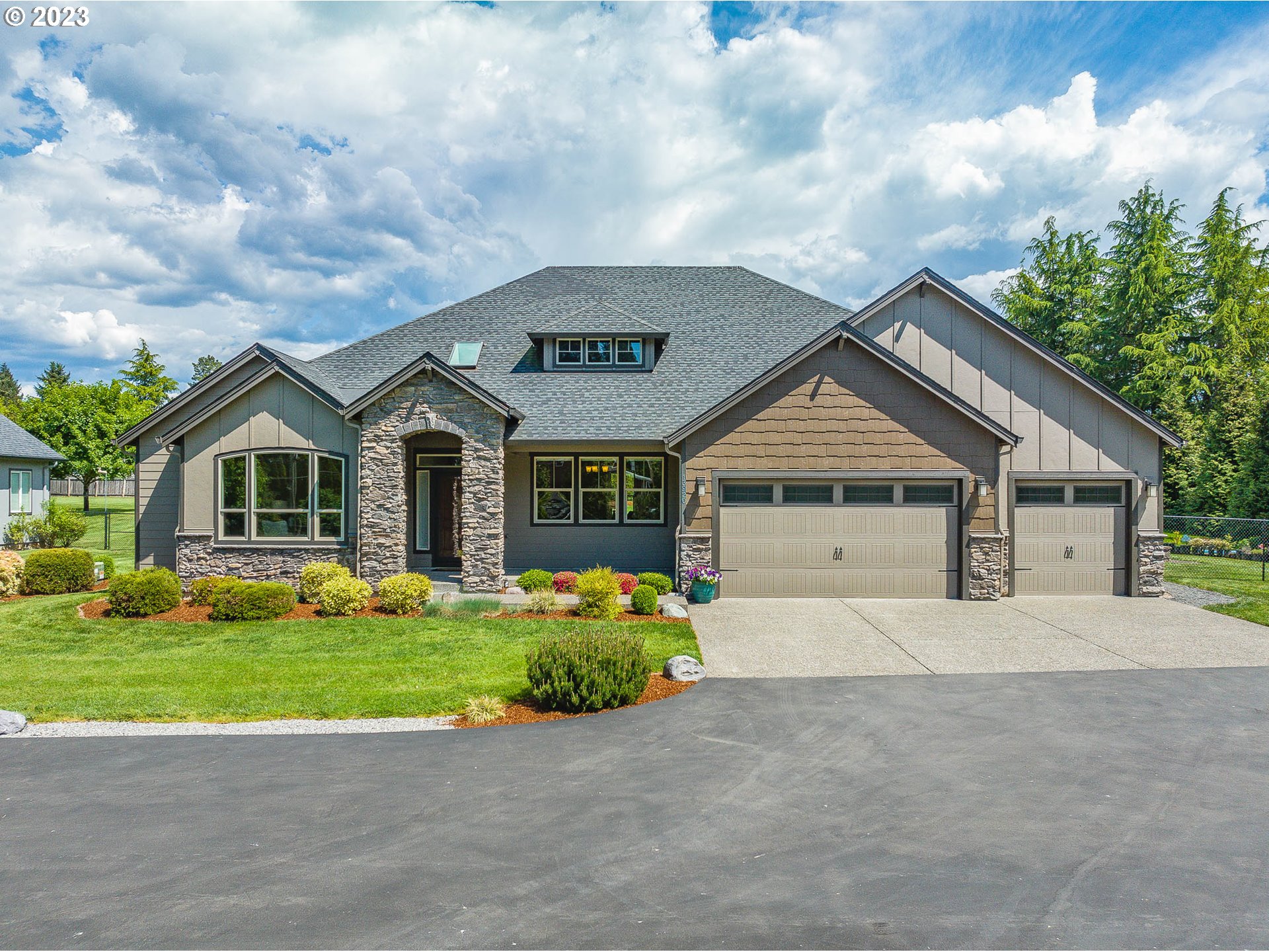 a front view of a house with a yard and garage