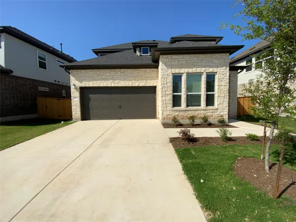 a front view of a house with a yard and porch