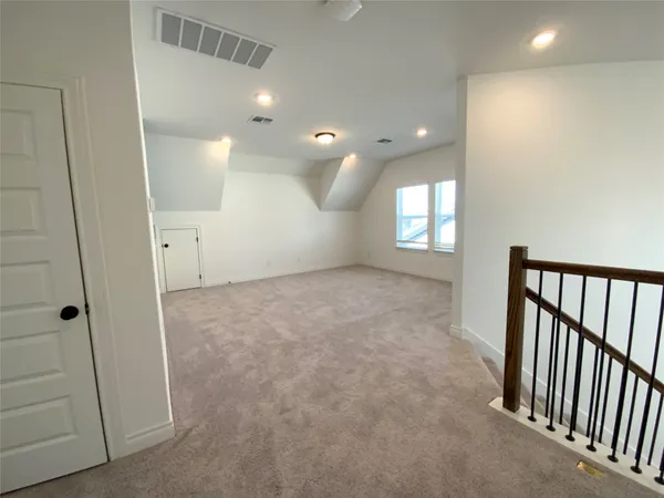 an empty room with windows and entrance