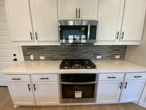 a stove top oven sitting inside of a kitchen