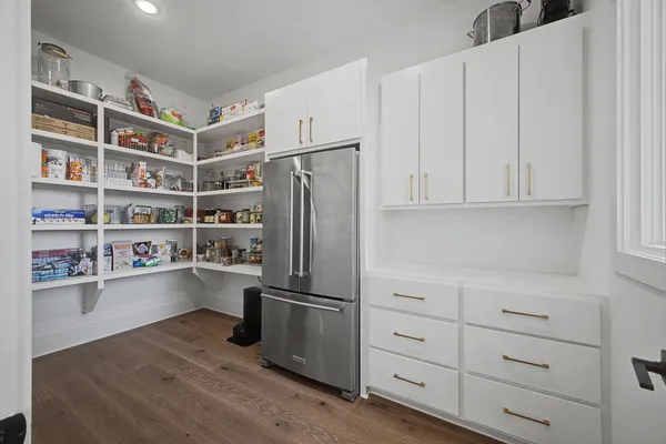 a living room with furniture and a kitchen view