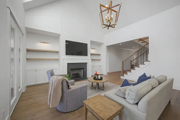 a large kitchen with a large counter top a sink stainless steel appliances and cabinets