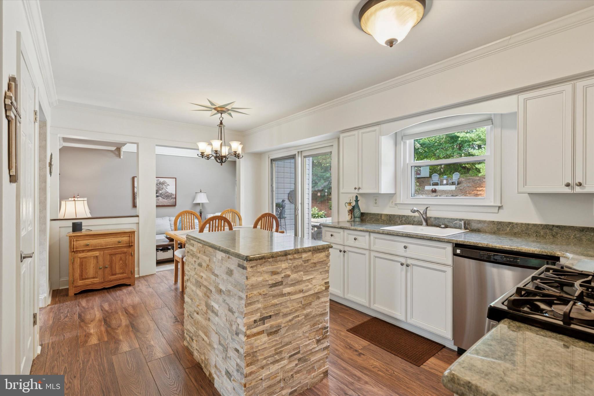 1402 Valley View Warrington, PA 18976 - Photo 13 of 51 a kitchen with stainless steel appliances granite countertop a stove top oven a sink dishwasher and white cabinets with wooden floor
