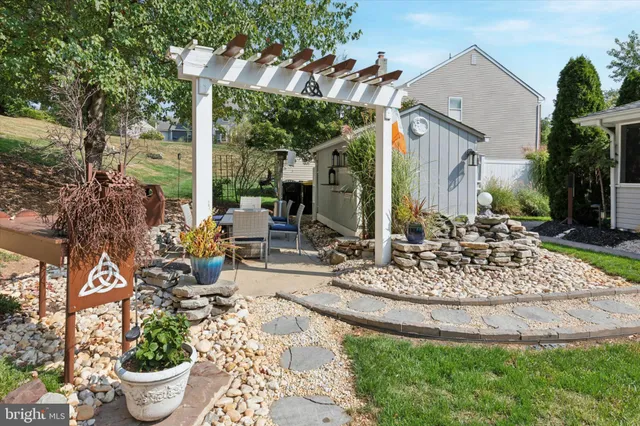 a view of a house with backyard and sitting area