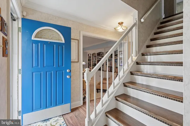 a view of staircase with wooden walls and floors