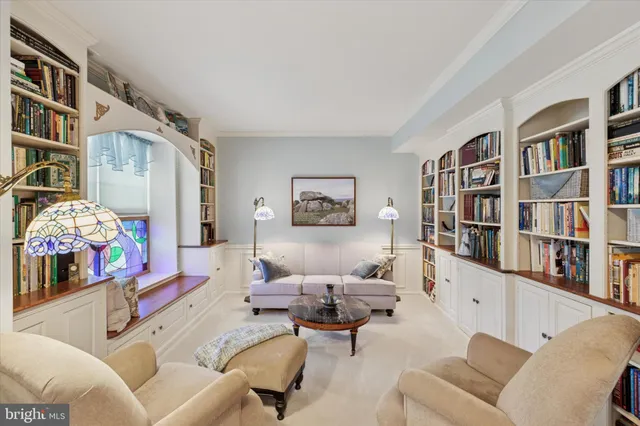 a living room with furniture workspace and a book shelf
