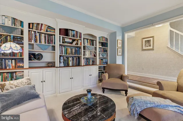 a bedroom with furniture and a book shelf