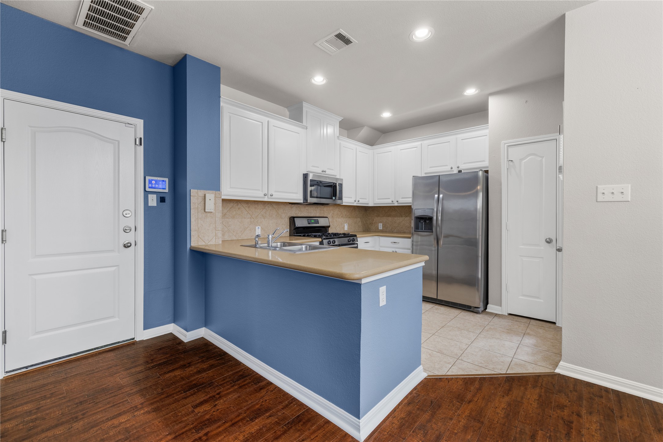 11000 Anderson Mill Road, Unit 45 Austin, TX 78750 - Photo 9 of 32 a kitchen with stainless steel appliances granite countertop a refrigerator a sink and a stove
