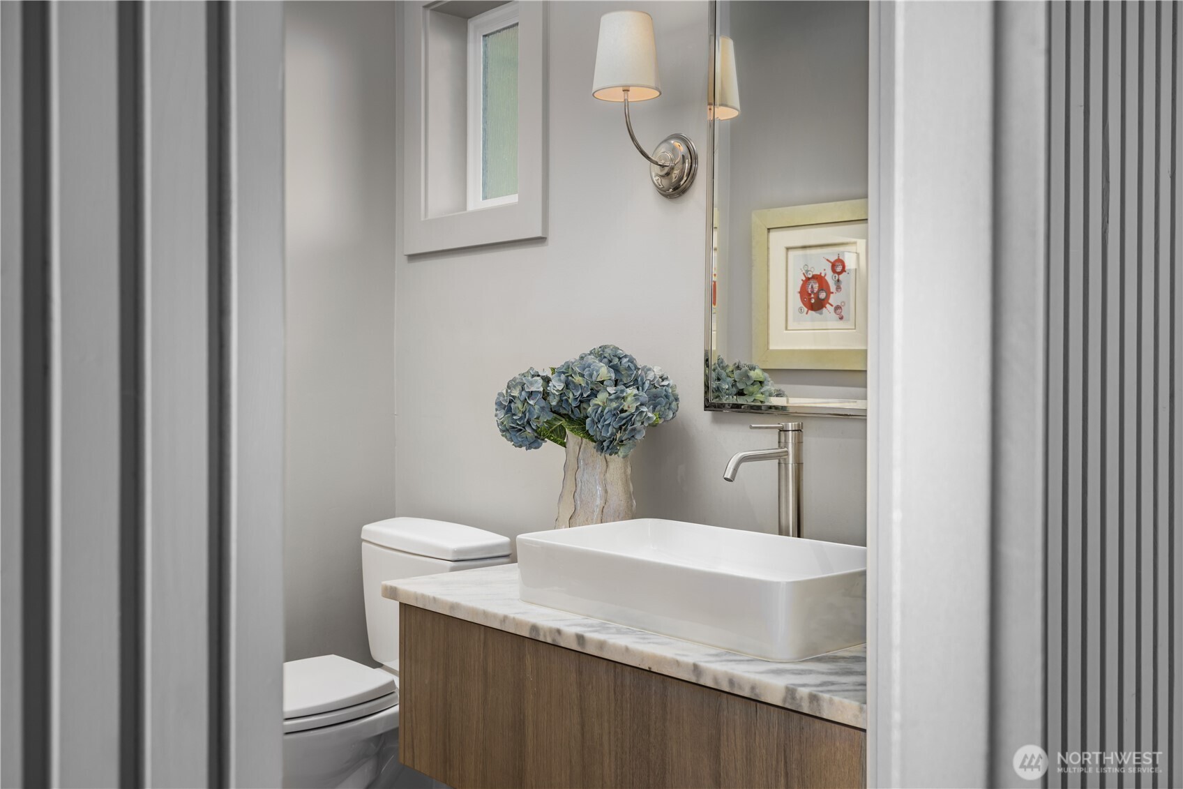 8097 West Mercer Way Mercer Island, WA 98040 - Photo 15 of 40 a bathroom with a granite countertop sink and a toilet