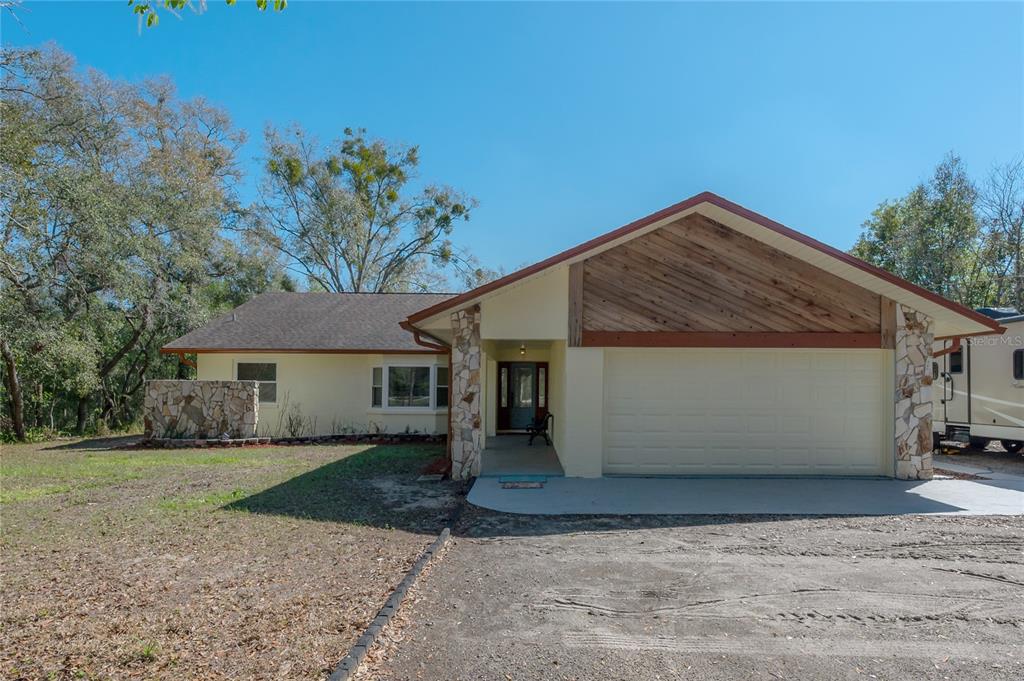 16740 Monteverde Drive Spring Hill, FL 34610 - Photo 1 of 1 a front view of a house with a yard and garage