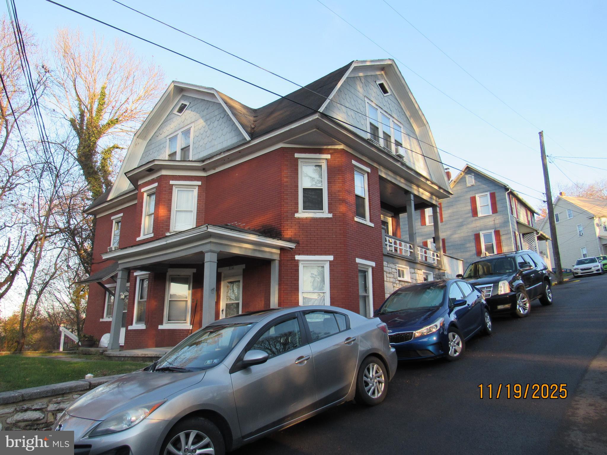 a front view of a house with parking space