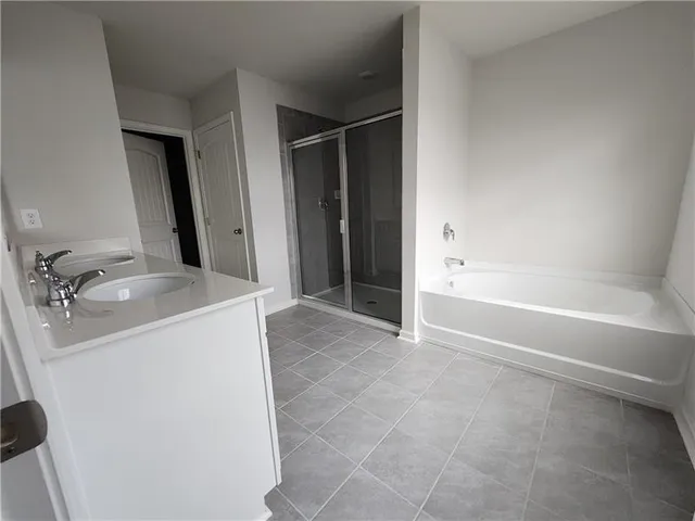 a bathroom with a glass shower door