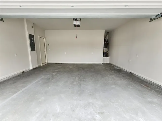 a view of a hallway with wooden floor and windows