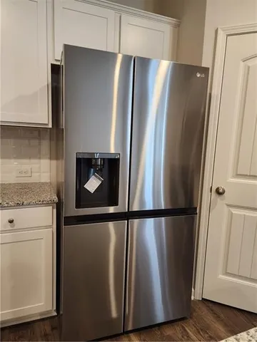 a refrigerator freezer sitting inside of a kitchen