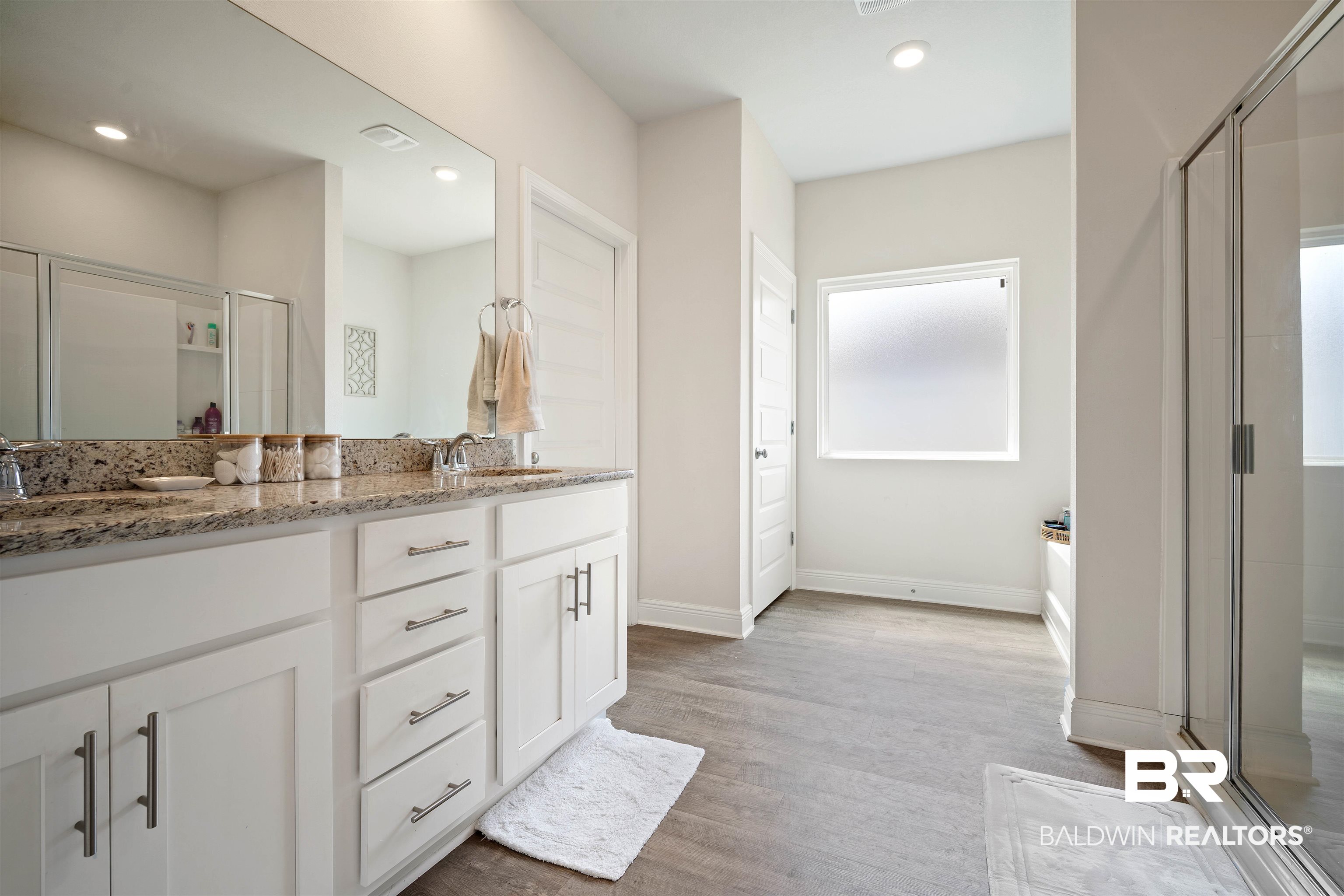 11021 Native Dancer Way Daphne, AL 36526 - Photo 14 of 35 Bathroom featuring double vanity, wood finished floors, a sink, baseboards, and a stall shower