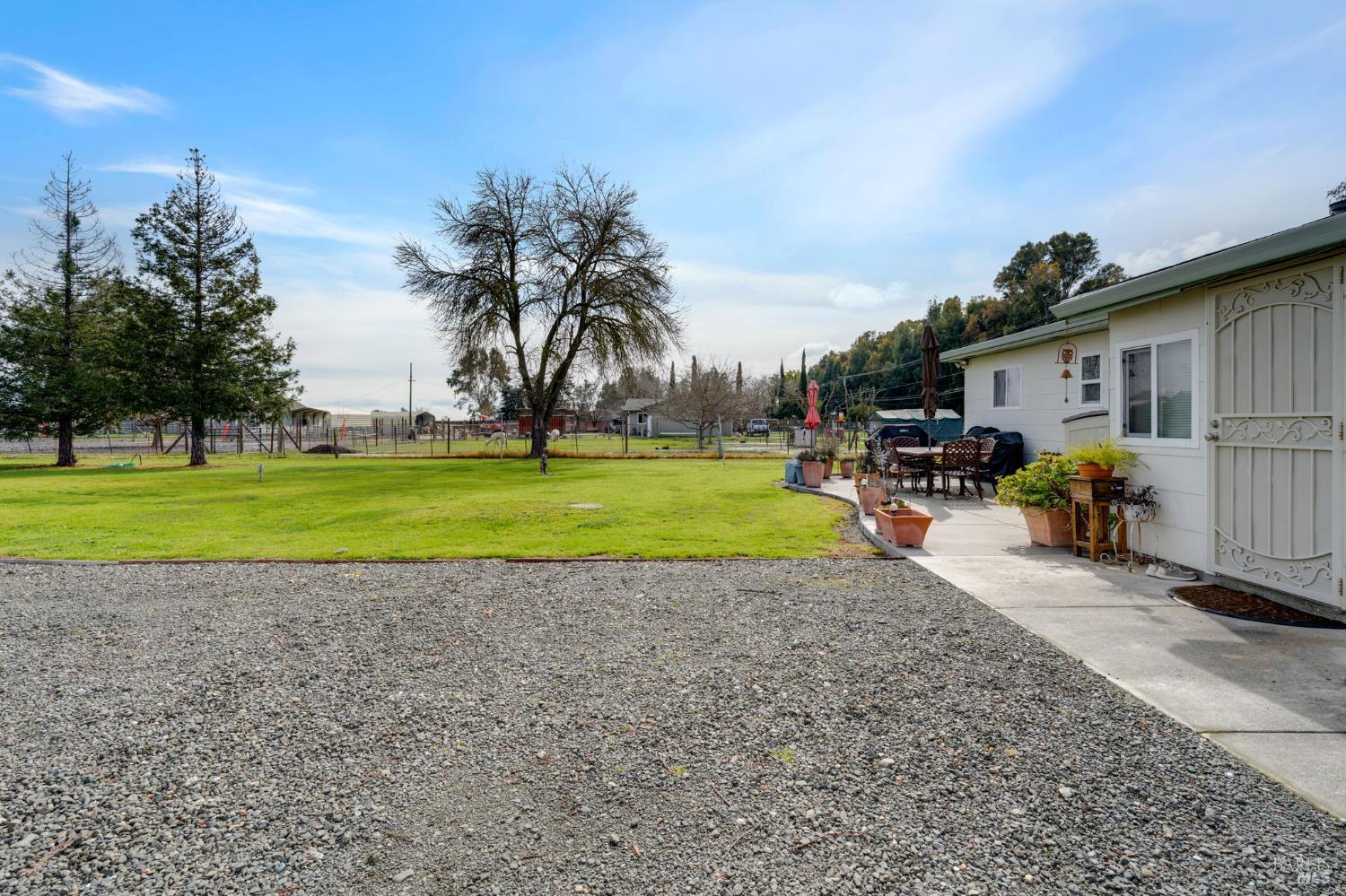 7500 North Meridian Road Vacaville, CA 95688 - Photo 16 of 38 a view of a house with backyard and a car parked